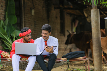 Poster - Young indian banker collection information to farmer at home