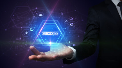 Man hand holding SUBSCRIBE inscription, social media concept