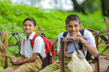 Cute indian child going to school on bullock cart and playing with pinwheel