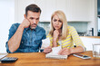 © baranq - Sad couple calculating home finances