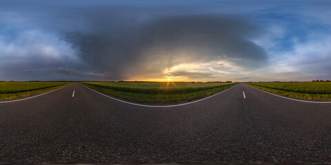 Wall Mural - full seamless spherical hdri panorama 360 degrees angle view on asphalt road among farm fields in autumn evening before sunset with storm clouds in equirectangular projection, ready for VR AR content