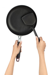 Wall Mural - Hand holding black Frying Pan with spatula isolated on white background