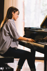 Young girl taking piano lesson in a grand piano