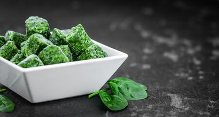 Wall Mural - Portion of frozen spinach (close up; selective focus)