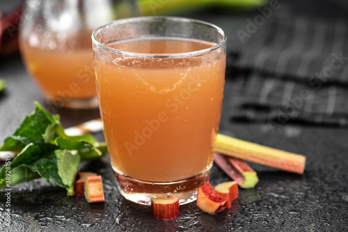 Rhubarb Juice on rustic background (close up; selective focus)