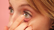 © CameraCraft - Close up, young caucasian woman putting contact lenses over her green eyes. High quality photo