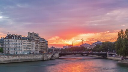 Wall Mural - Le Pont D'Arcole bridge at sunset with people and boats timelapse, Paris, France, Europe. Colorful sky at summer day with reflection on river Seine