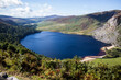 WICKLOW COUNTY, LOUGH TAY, IRELAND - SEPTEMBER 12, 2018: Know as Guiness Lake, Lough Tay is fed by Cloghoge River. Sunny autumn day, dark blue water.