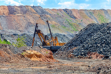 Big excavator working in iron ore quarry. Mining industry