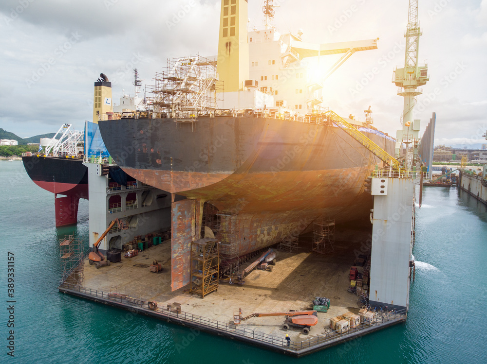 Cargo container ship stern with propeller at dry dock for maintenance follow annual plan and service.