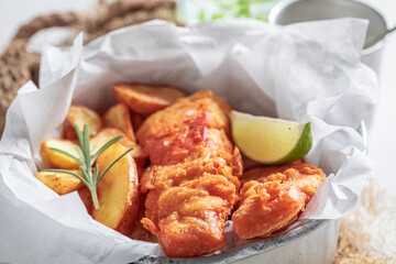 Delicious fish and chips served with lime and salt