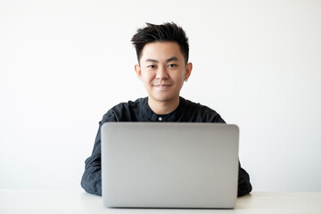 Freelancer lifestyle. Remote job. Professional career. Portrait of confident relaxed asian guy using laptop looking at camera smiling isolated on white copy space background.