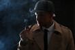 © New Africa - Old fashioned detective smoking pipe on dark background