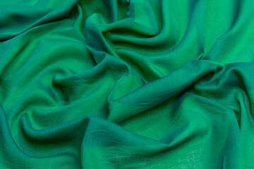 Smooth elegant green silk satin luxury texture using as abstract background for luxurious pattern design