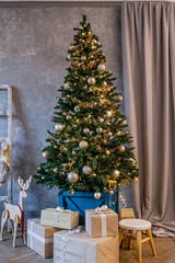 christmas tree with colorful balls and gift boxes in the room.