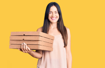 Sticker - Young beautiful caucasian woman holding delivery pizza box looking positive and happy standing and smiling with a confident smile showing teeth