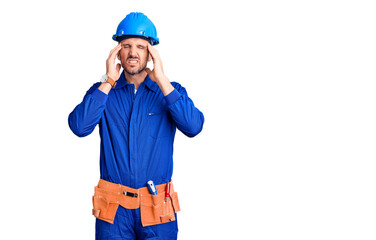 Canvas Print - Young handsome man wearing worker uniform and hardhat touching forehead for illness and fever, flu and cold, virus sick