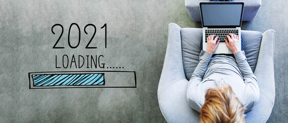 Poster - Loading new year 2021 with man using a laptop in a modern gray chair