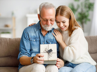 Happy father and daughter examining gift