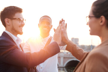 Poster - Young successful managers of various ethnicities giving each other high five