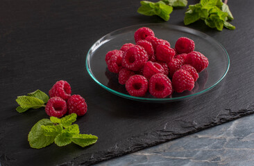 Wall Mural - sweet juicy raspberries lie on a saucer