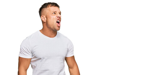 Sticker - Handsome muscle man wearing casual white tshirt angry and mad screaming frustrated and furious, shouting with anger. rage and aggressive concept.