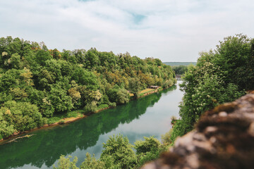 Canvas Print - Fascinating Korana river coloured in green as the dense forest in its surroundings, beautiful tourist destination near the city of Karlovac, Croatia