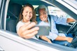 © Krakenimages.com - Middle age couple in love sitting inside the car going for a trip taking a selfie picture with smartphone smiling happy and cheerful together