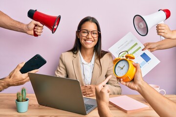 Canvas Print - Beautiful hispanic woman working at the office under stress looking positive and happy standing and smiling with a confident smile showing teeth