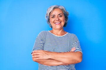 Wall Mural - Senior hispanic grey- haired woman wearing casual clothes happy face smiling with crossed arms looking at the camera. positive person.