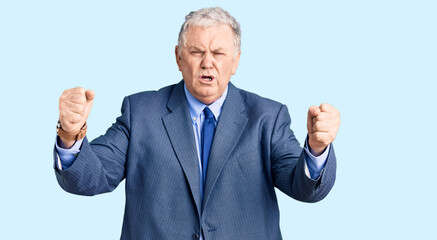 Canvas Print - senior grey-haired man wearing business jacket angry and mad raising fists frustrated and furious wh