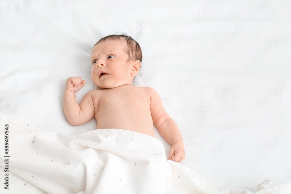 Cute little baby lying on bed