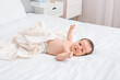 © Pixel-Shot - Cute little baby lying on bed at home