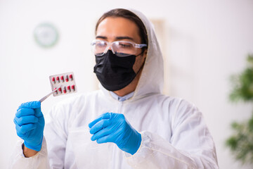 Wall Mural - Male expert criminologist working in the lab for evidence