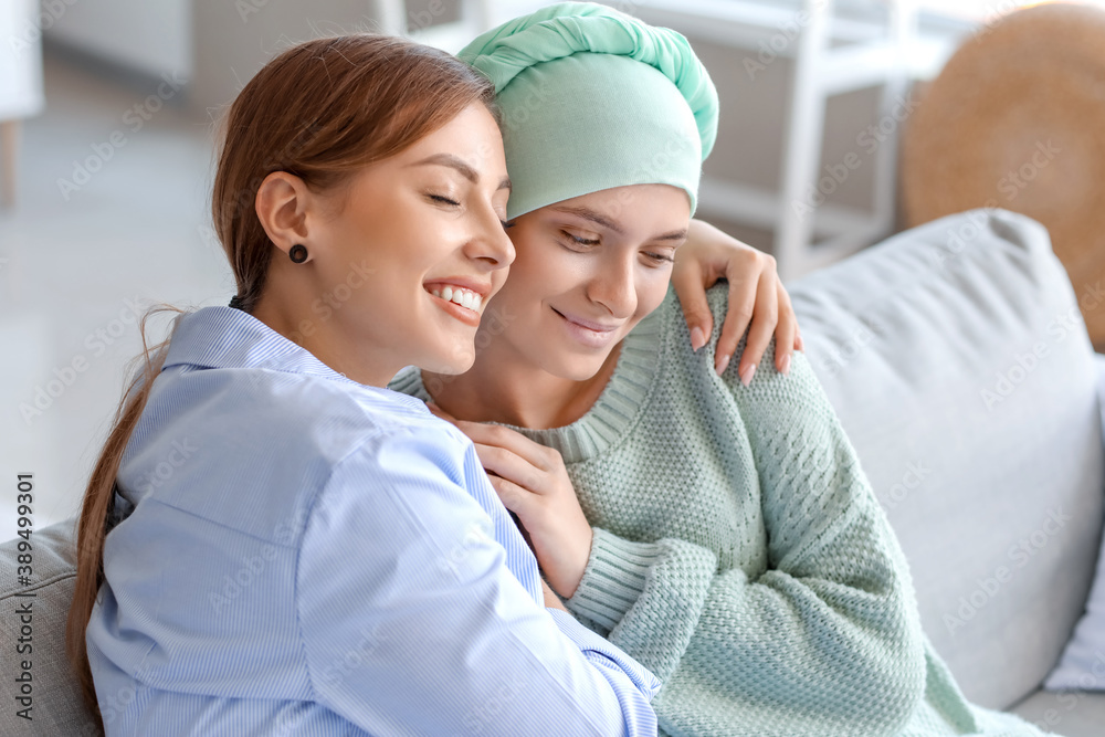 Woman supporting her sister after chemotherapy at home