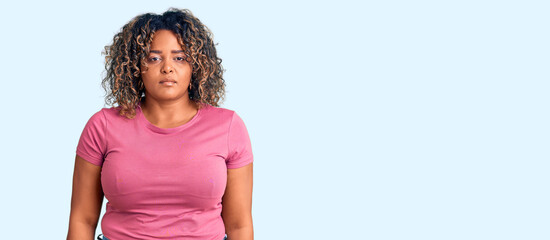 Wall Mural - Young african american plus size woman wearing casual clothes relaxed with serious expression on face. simple and natural looking at the camera.