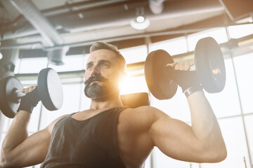 Training in gym, Handsome man with a mustache, do muscle building exercises using dumbbells, focusing on lifting and sit-ups in a fitness sport.