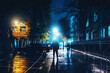 Silhouette of alone stranger in hood at night city street in rain. Creepy killer or stalker, criminal stands in shadow with urban lights reflected in puddles. Thriller horror mysterious atmosphere.