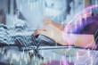 © peshkova - Multi exposure of woman hands typing on computer and financial graph hologram drawing. Stock market analysis concept.