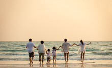 Happy Multi Generation Asian Family Holding Hands And Walking On The Beach Together At Summer Sunset. Smiling Big Family Parents With Child Boy And Girl Enjoy In Outdoors Lifestyle Travel Vacation