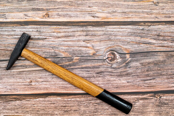 Hammer on a wooden table. Locksmith work table with tools in the workshop. Flat lay with copy space.