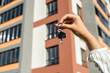 © RomanR - Keys from new home in broker hands on house background