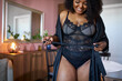 © Roman - good-looking black woman wearing silk dressing gown at home, attractive female has pretty sexy plus size figure. indoors