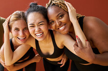 Three Young Diverse Multi Ethnic Female Models Of Different Race, Hair Colour And Body Size Posing At Camera, Friendly Females In Black Sportswear. Tolerance And Natural Beauty Concept