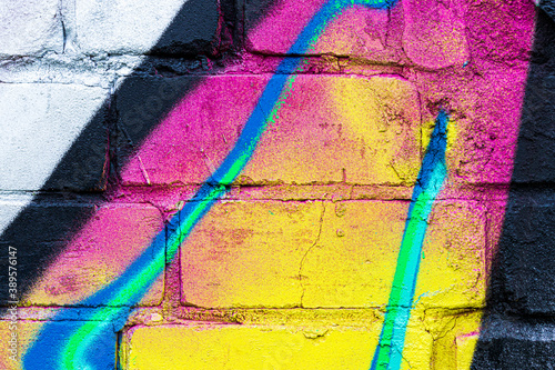 A fragment of colorful graffiti painted on a brick wall Canvas Print