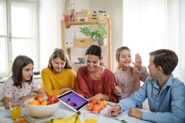 Wall Mural - Group of homeschooling children with teacher studying indoors, coronavirus concept.