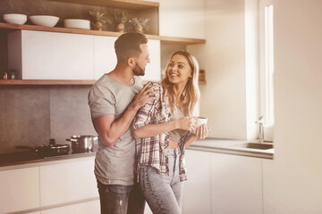 Wall Mural - cheerful couple in the kitchen on a good morning