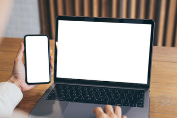 computer,cell phone mockup.hand woman work using laptop texting mobile.blank screen with white background for advertising,contact business search information on desk in cafe.marketing,design