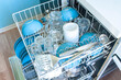 © Alex Kukina - Dishwasher after cleaning process, both baskets are opened Clean dishes: bowls, glasses, kitchenware, close up, top view