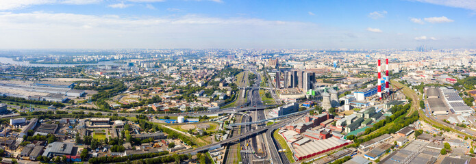 Wall Mural - Power plant pipes and cooling towers in Moscow from above, automobile traffic and and construction of a new car overpass and interchange in the Moscow industrial zone near the automobile ring highway.